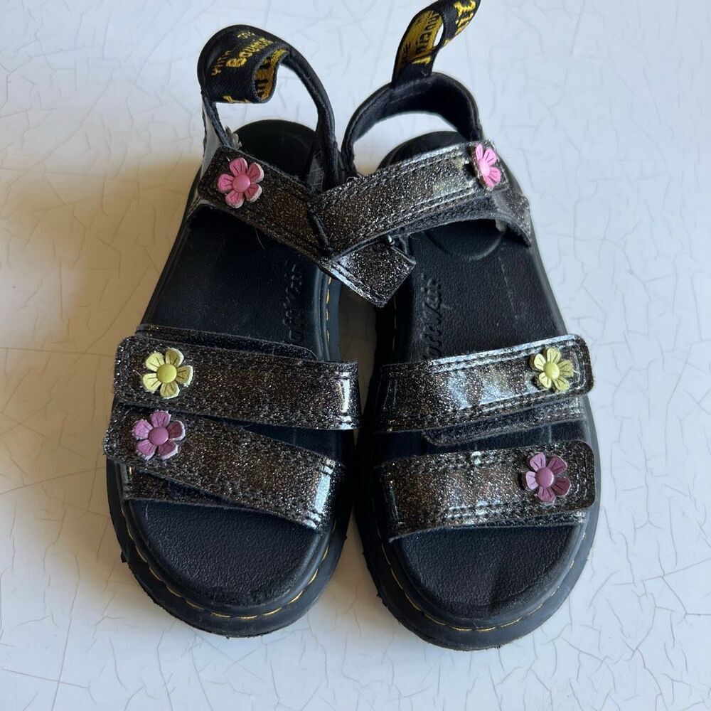 Dr. Martens Junior Klaire Coated Glitter Sandals featuring floral appliqués